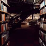 An Author Trying to beat Writer's Block ~ Assorted Books in Library