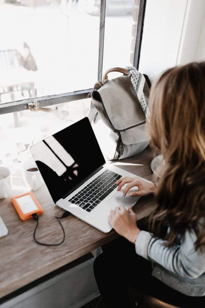 Close-up Photography of Woman Sitting Beside Table While Using Macbook - when the writing won't come