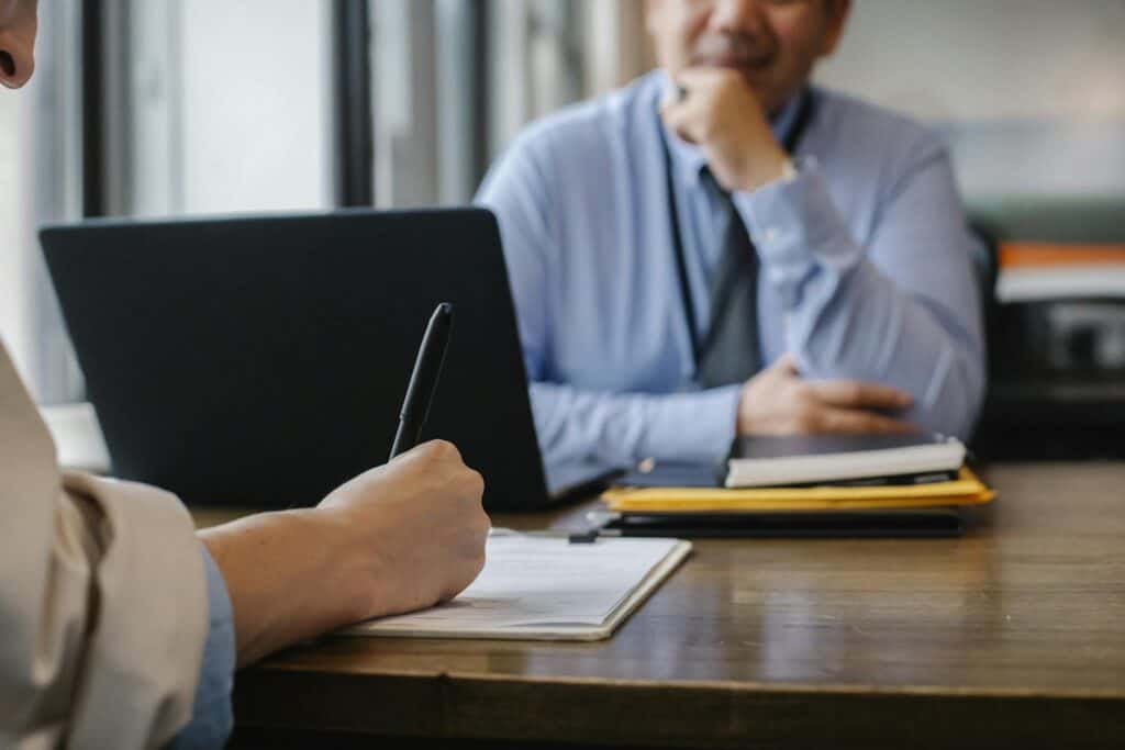 A male accountant is sitting at his desk and appears to be focused on his work, which may be perceived as mundane or unexciting.