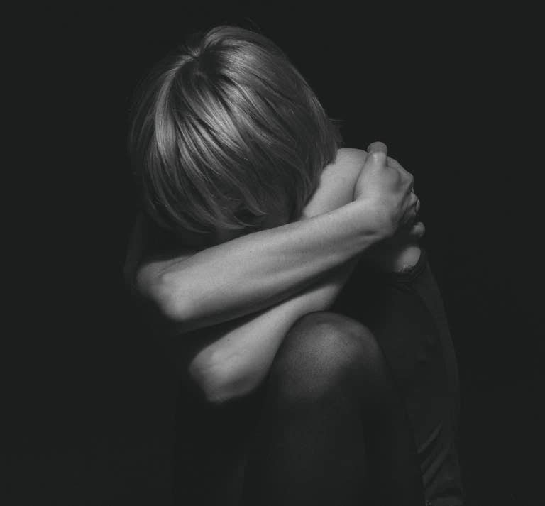 Cutting Words ~ Grayscale Photo of a Person Hugging Self