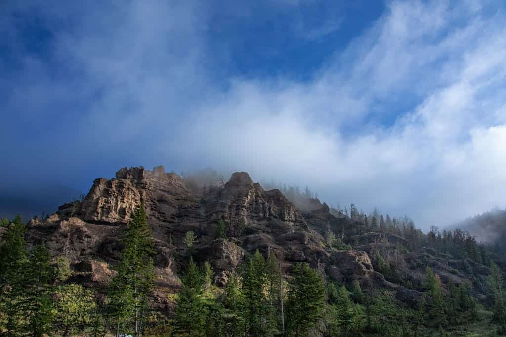 Writing Advice ~ My Three favorite Authors ... 3 Writing Advice ~ Stunning view of rugged mountains with lush green conifers under dramatic clouds.